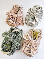 Four fabric wraps with different patterns on a white background