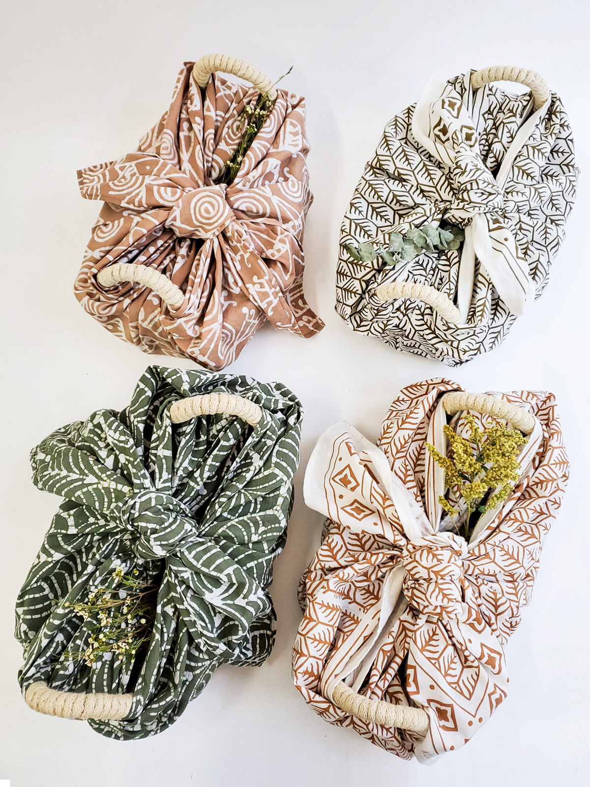 Four fabric wraps with different patterns on a white background