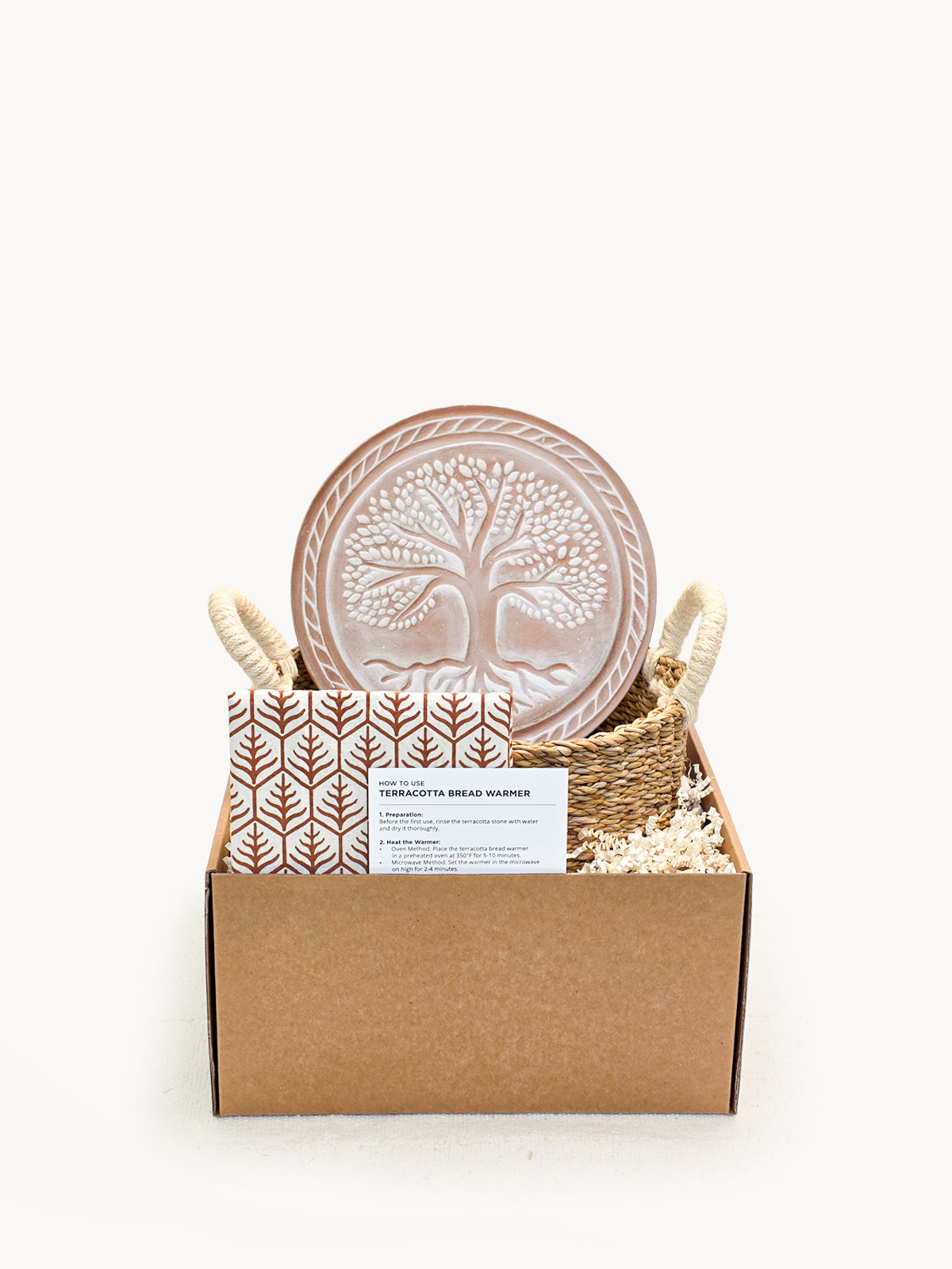 Gift set with decorative plates, basket, and card in a box on a white background