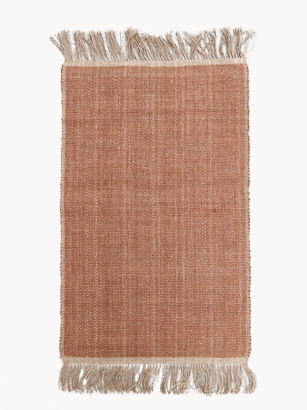 Textured pink rug with fringes on a white background