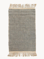 Textured rug with fringes on a white background