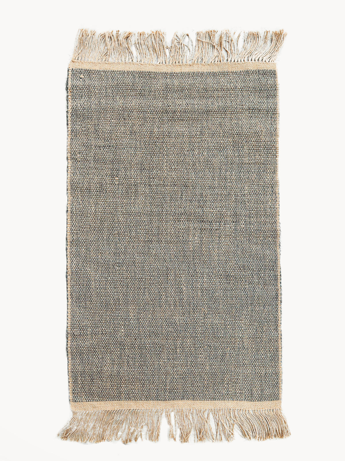 Textured rug with fringes on a white background