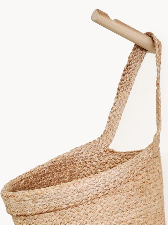 Woven basket with a wooden handle on a white background
