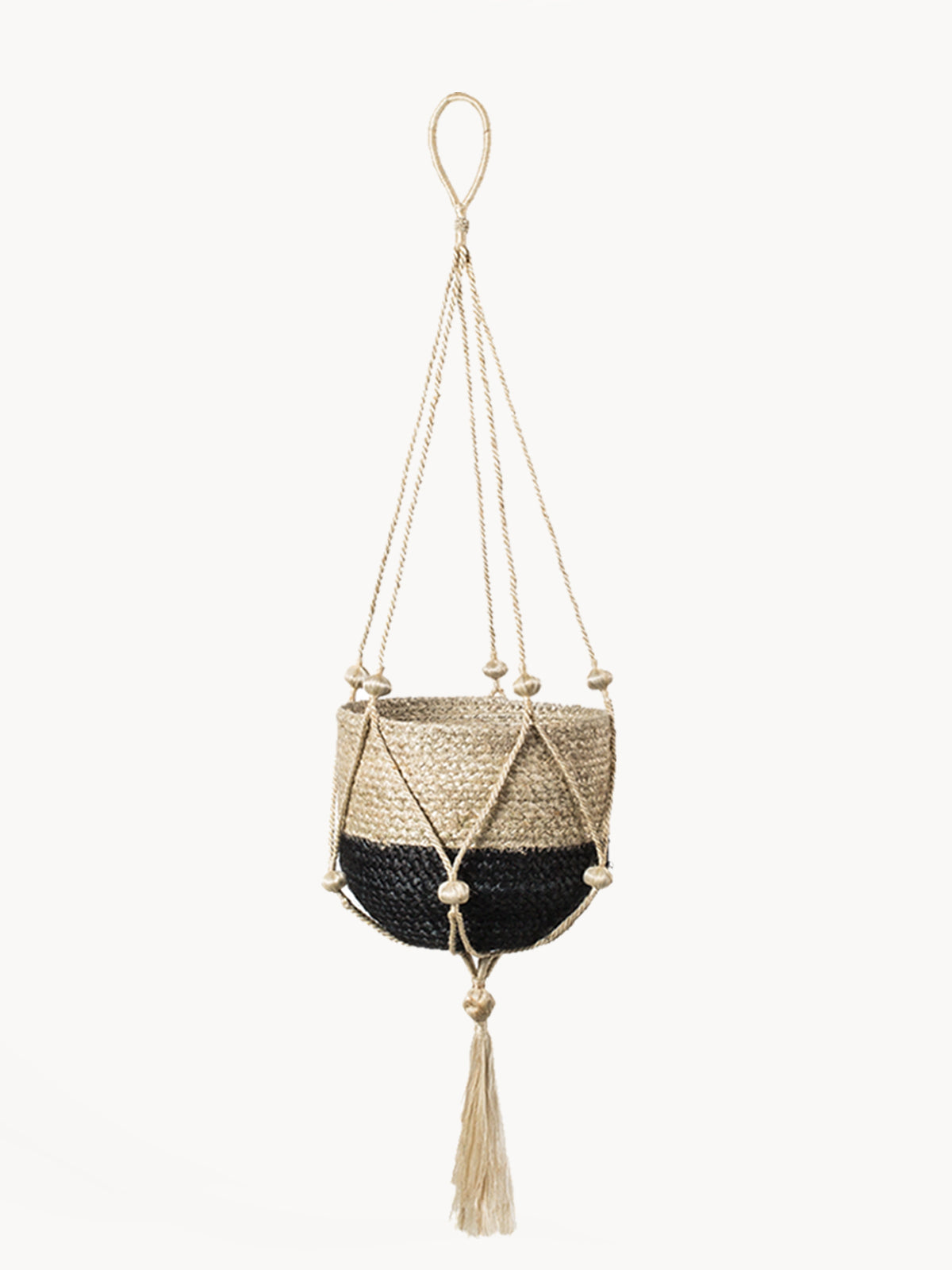 Woven plant hanger with black base and beige top, featuring tassels on a white background.