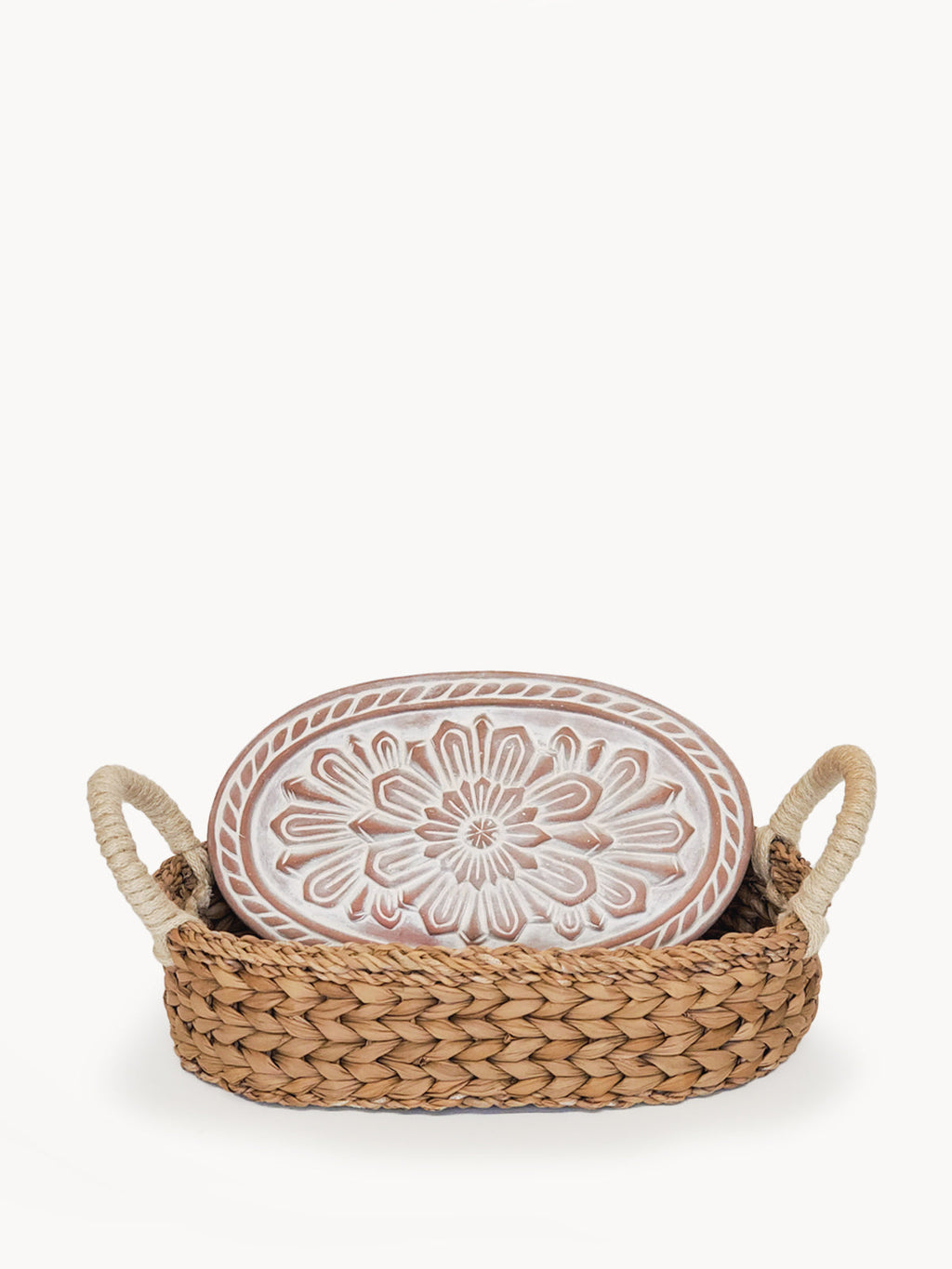 Decorative plate with floral design in a woven basket on a white background
