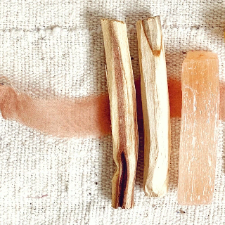 Two wooden sticks on a textured fabric background