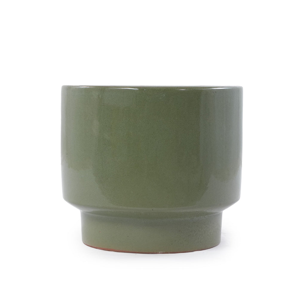 A matte sage green ceramic cup with a wide rim and a short flared base, shown on a plain white background.