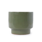 A matte sage green ceramic cup with a wide rim and a short flared base, shown on a plain white background.