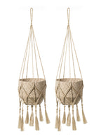 Two beige macrame plant hangers with tassels on a white background