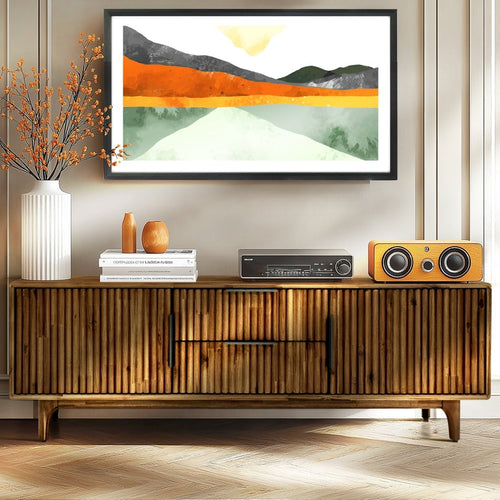 Wooden entertainment console with speakers, framed artwork above, and decorative items.