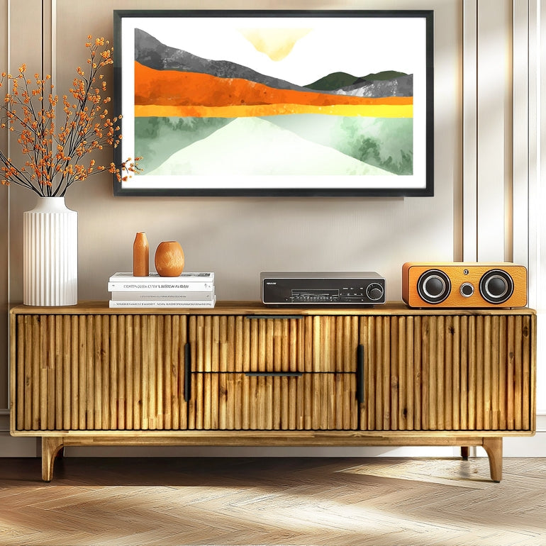 Wooden entertainment console with decorative items against a wall with a framed landscape painting.