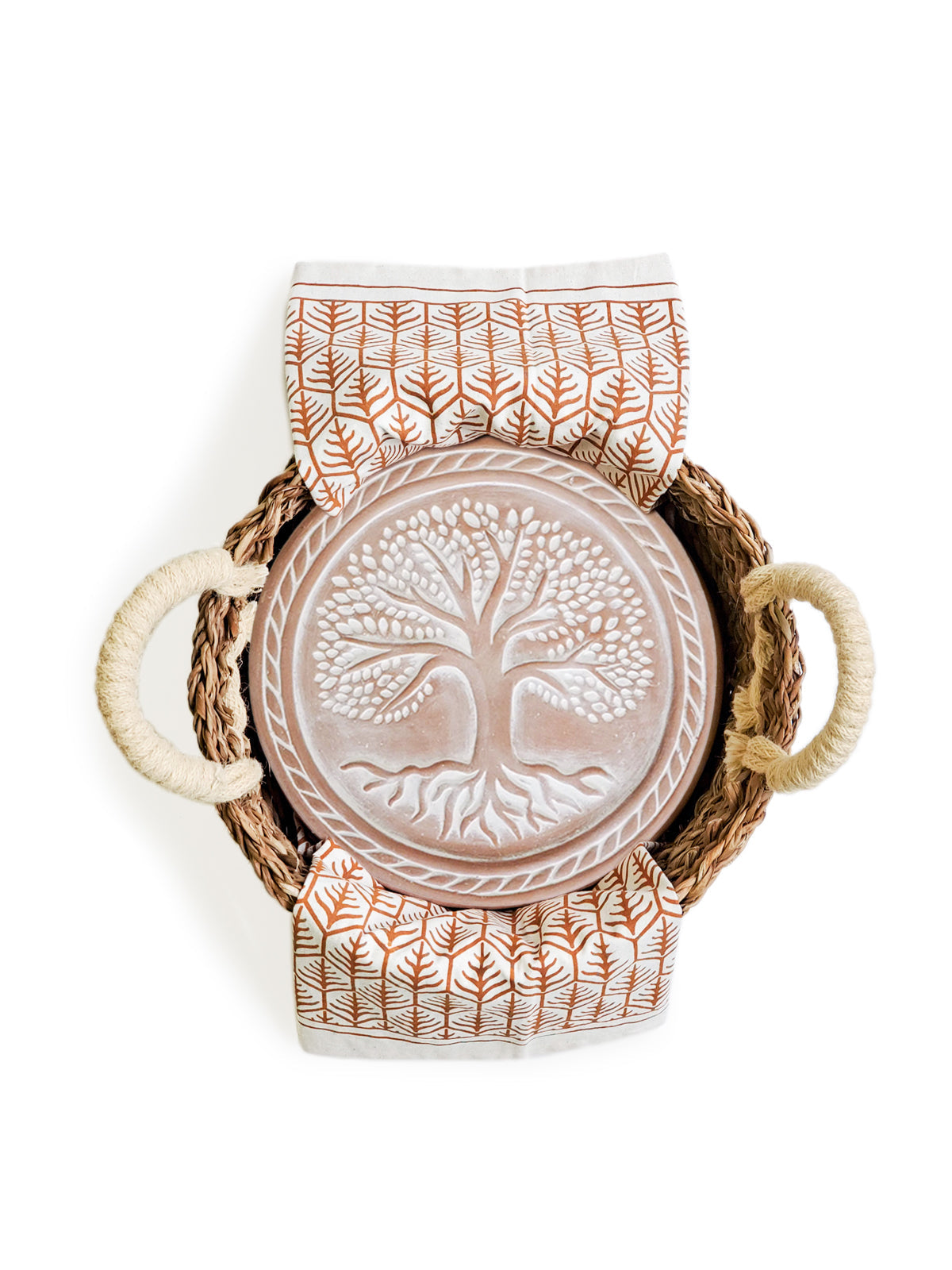 Decorative plate with tree design in a woven basket on a white background