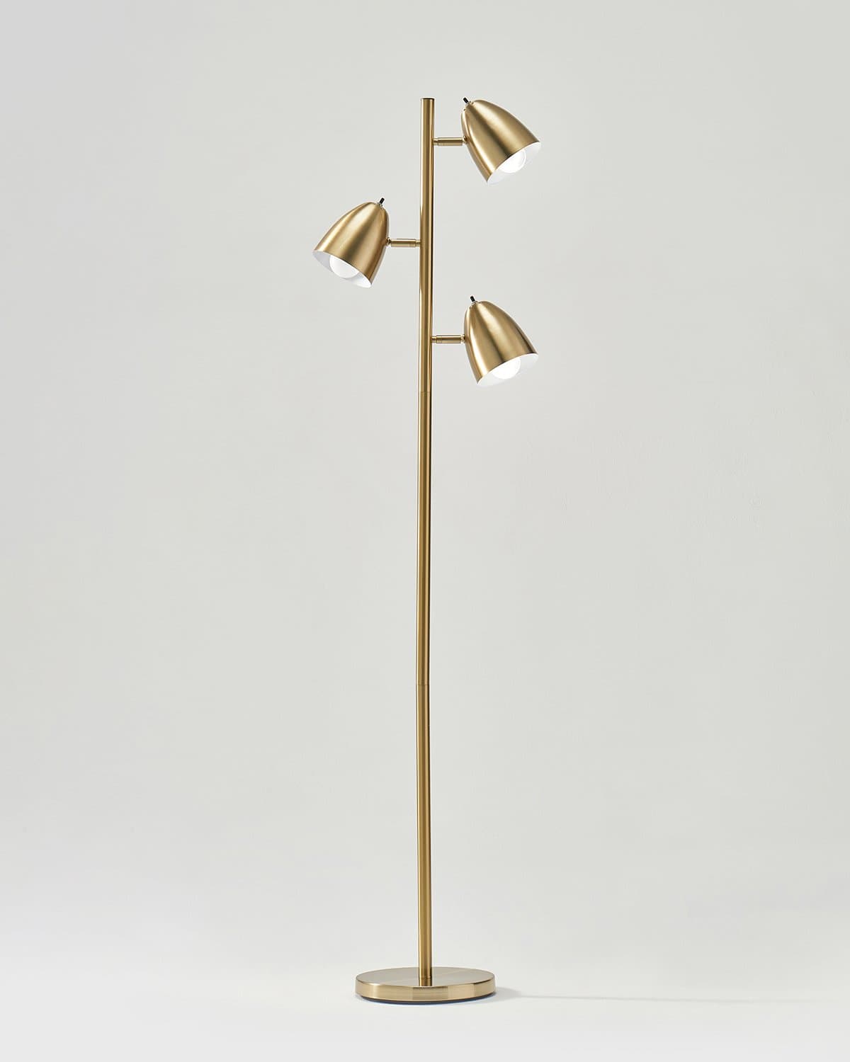 Gold floor lamp with three light bulbs on a white background