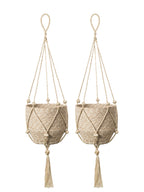 Two beige macrame plant hangers with tassels on a white background