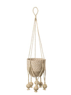 Beige woven plant hanger with decorative elements on a white background