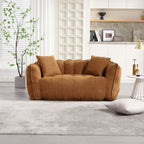 Brown sofa in a living room with a plant and shelves in the background