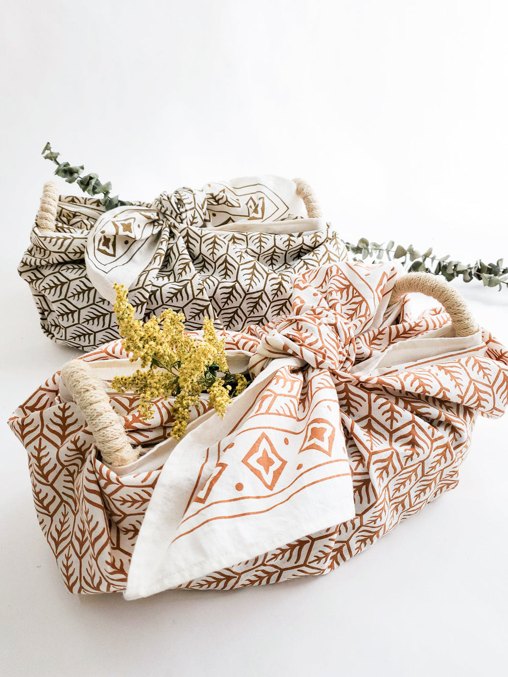 Set of three fabric bags with geometric patterns on a white background