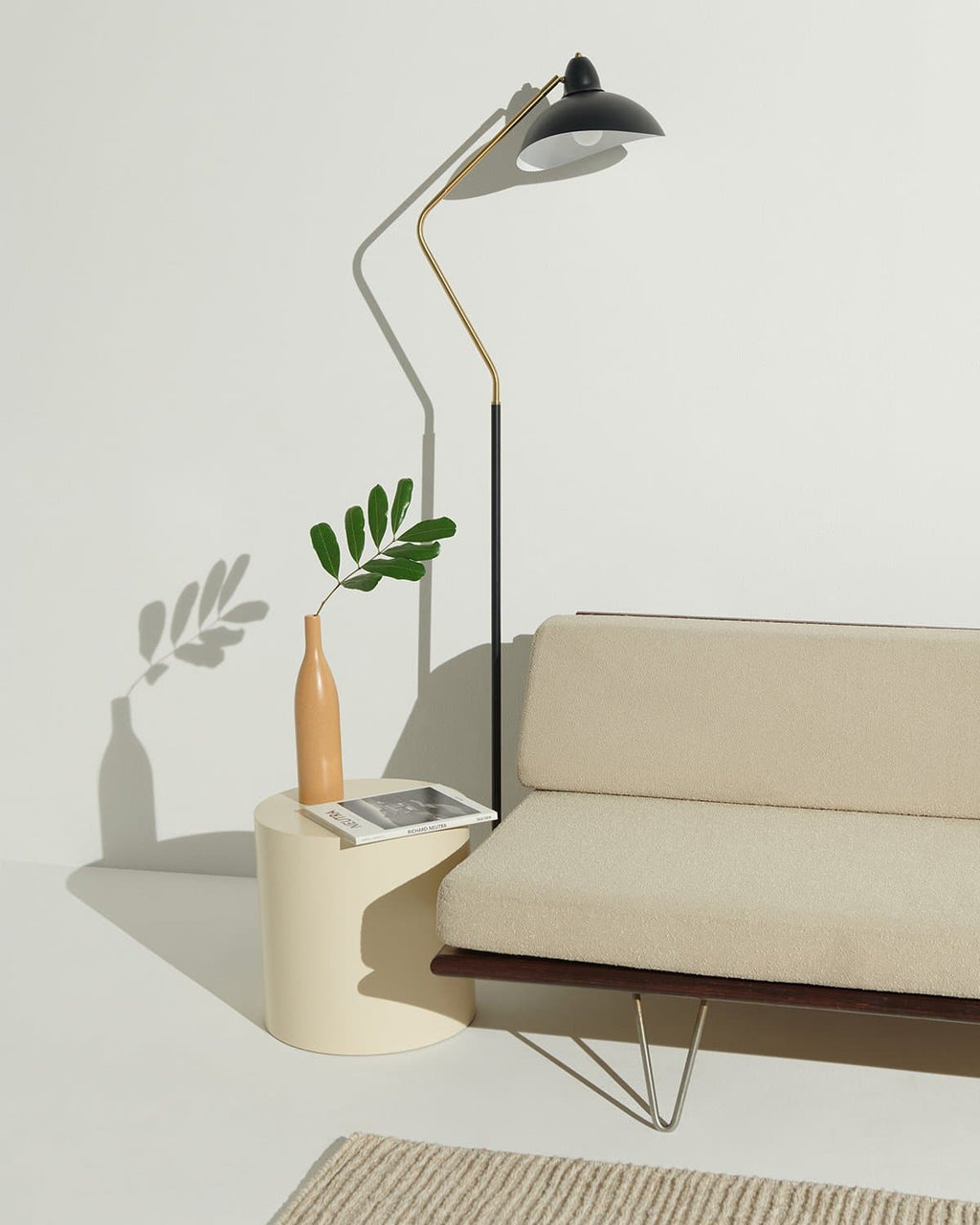 Modern living room with a beige sofa, floor lamp, and side table.