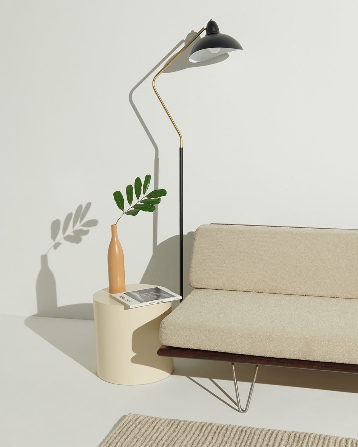 Modern living room with a beige sofa, floor lamp, and side table.