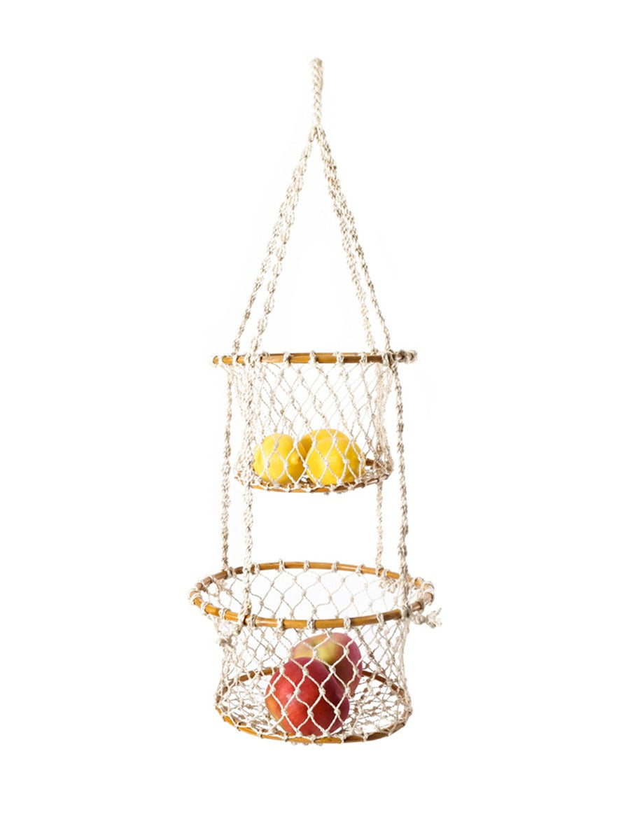 Hanging net fruit basket with apples and lemons on a white background