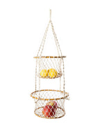 Hanging net fruit basket with apples and lemons on a white background