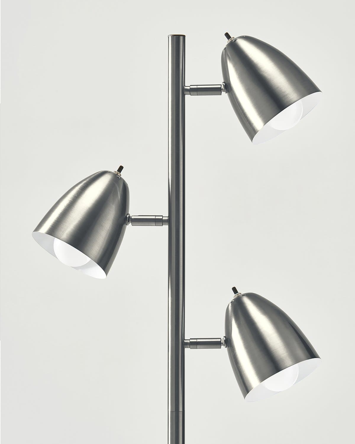 Modern floor lamp with three metallic lampshades on a white background