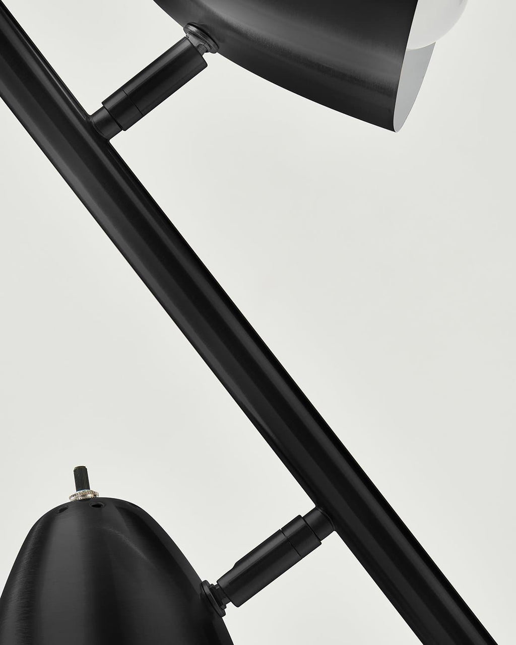 Close-up of a black floor lamp with a white background