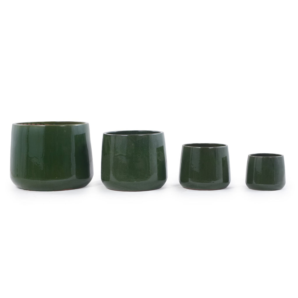Four dark green glazed ceramic planters in graduated sizes, arranged in a row against a plain white background.