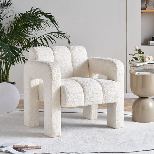 White textured armchair in a modern living room setting with a plant and side table.