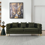 Green sofa in a living room with a butterfly painting on the wall.