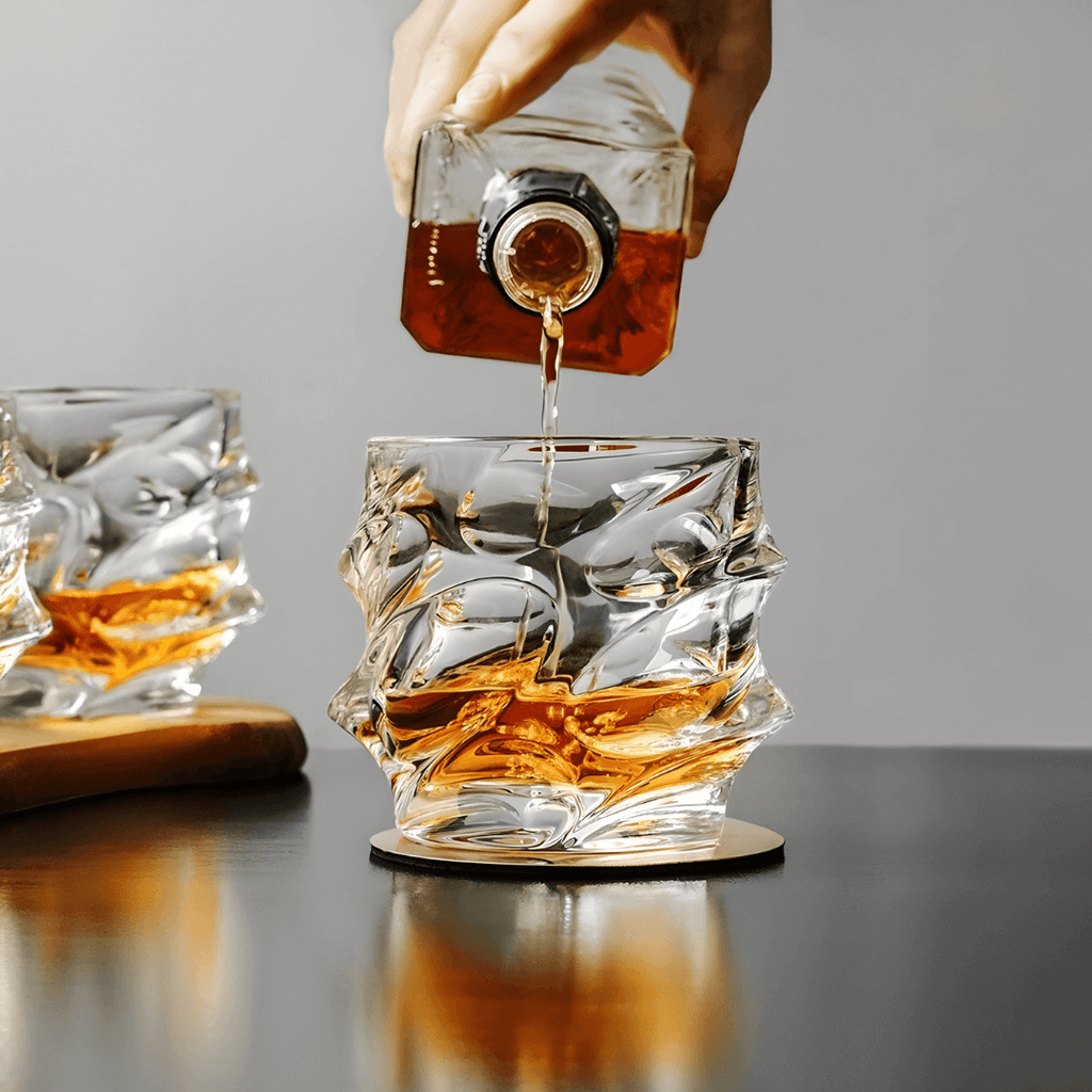 Whiskey being poured into a decorative glass with a blurred background