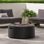 Outdoor patio setting with a fire pit table, gray cushions, and a potted plant.