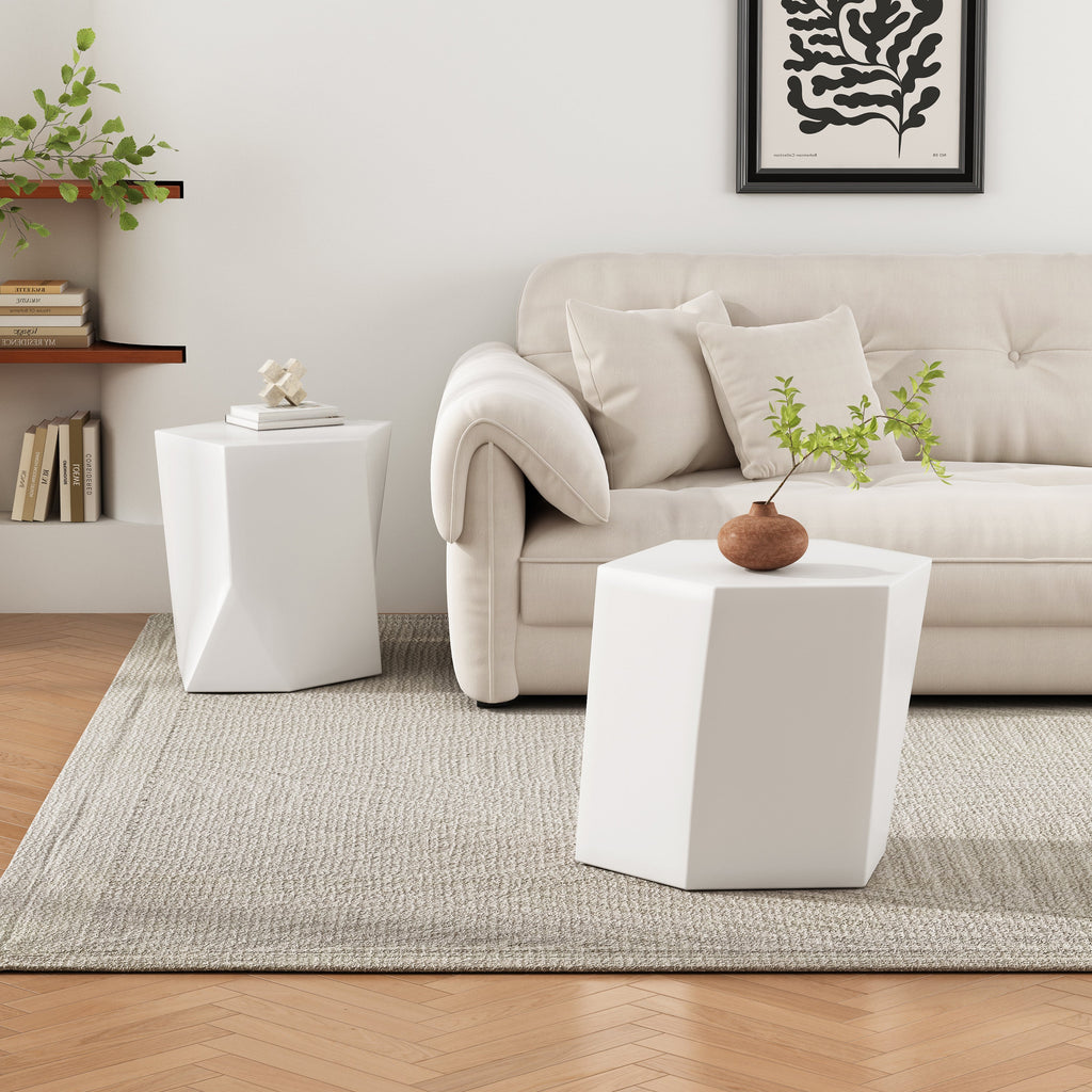 Modern living room with a beige sofa, white side tables, and decorative elements.