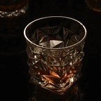 Crystal glass with textured design on a dark background