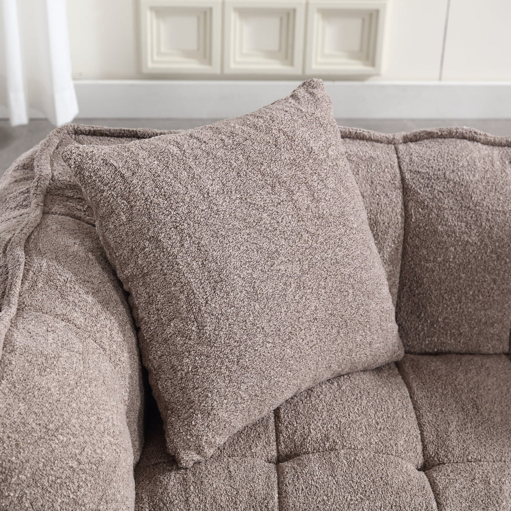 Brown textured pillow on a sofa with a neutral background