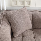Brown textured pillow on a sofa with a neutral background