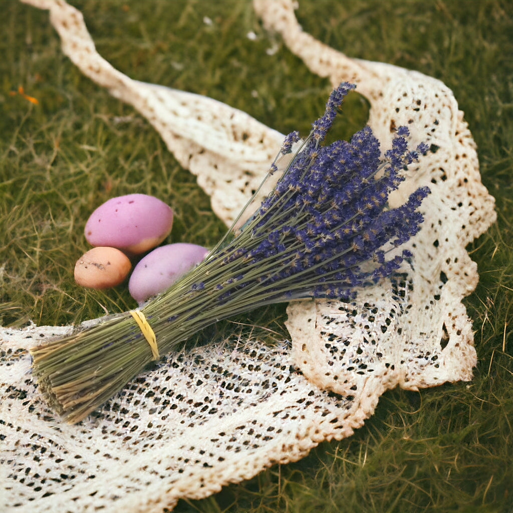 Bouquet of lavender and Easter eggs on a textured fabric with a green background