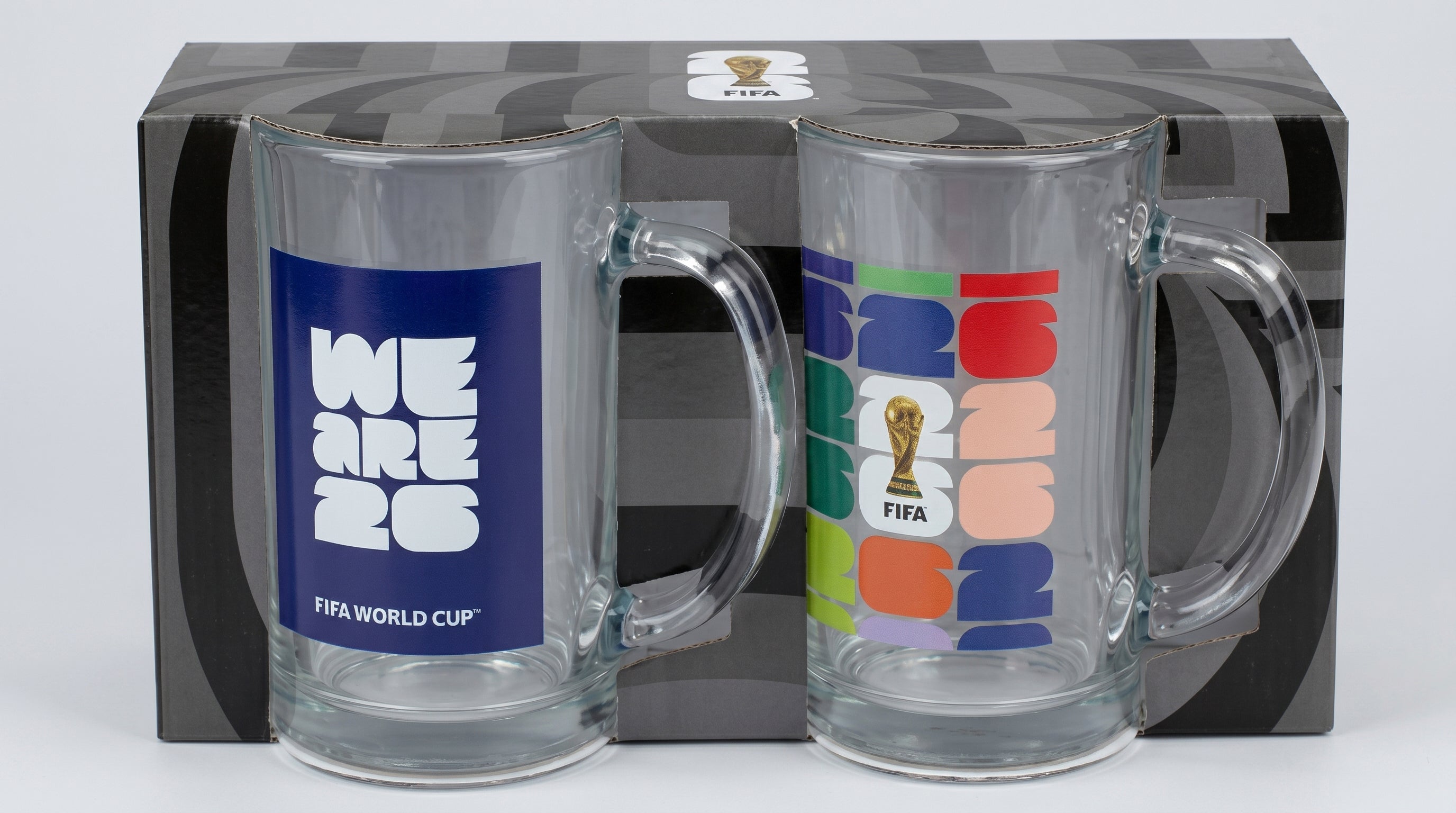 Two glass mugs with FIFA World Cup branding in front of a branded box.
