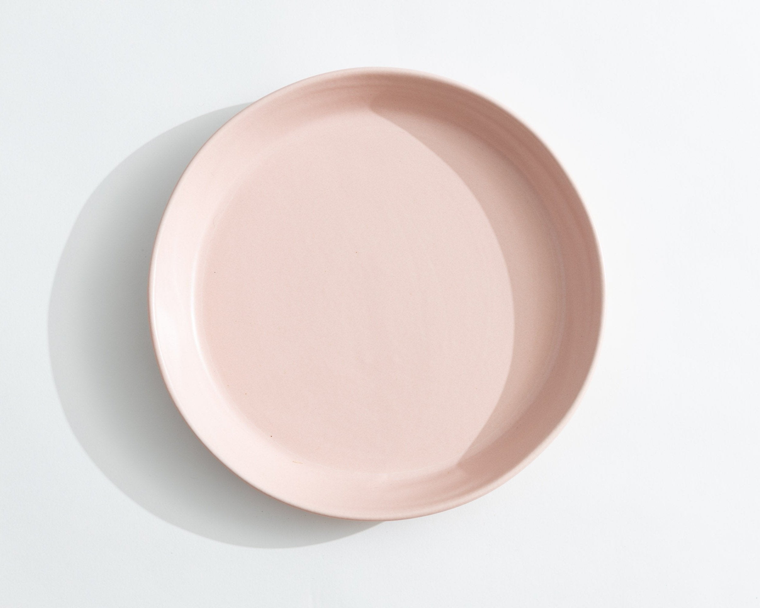 Pink ceramic plate on a light gray background