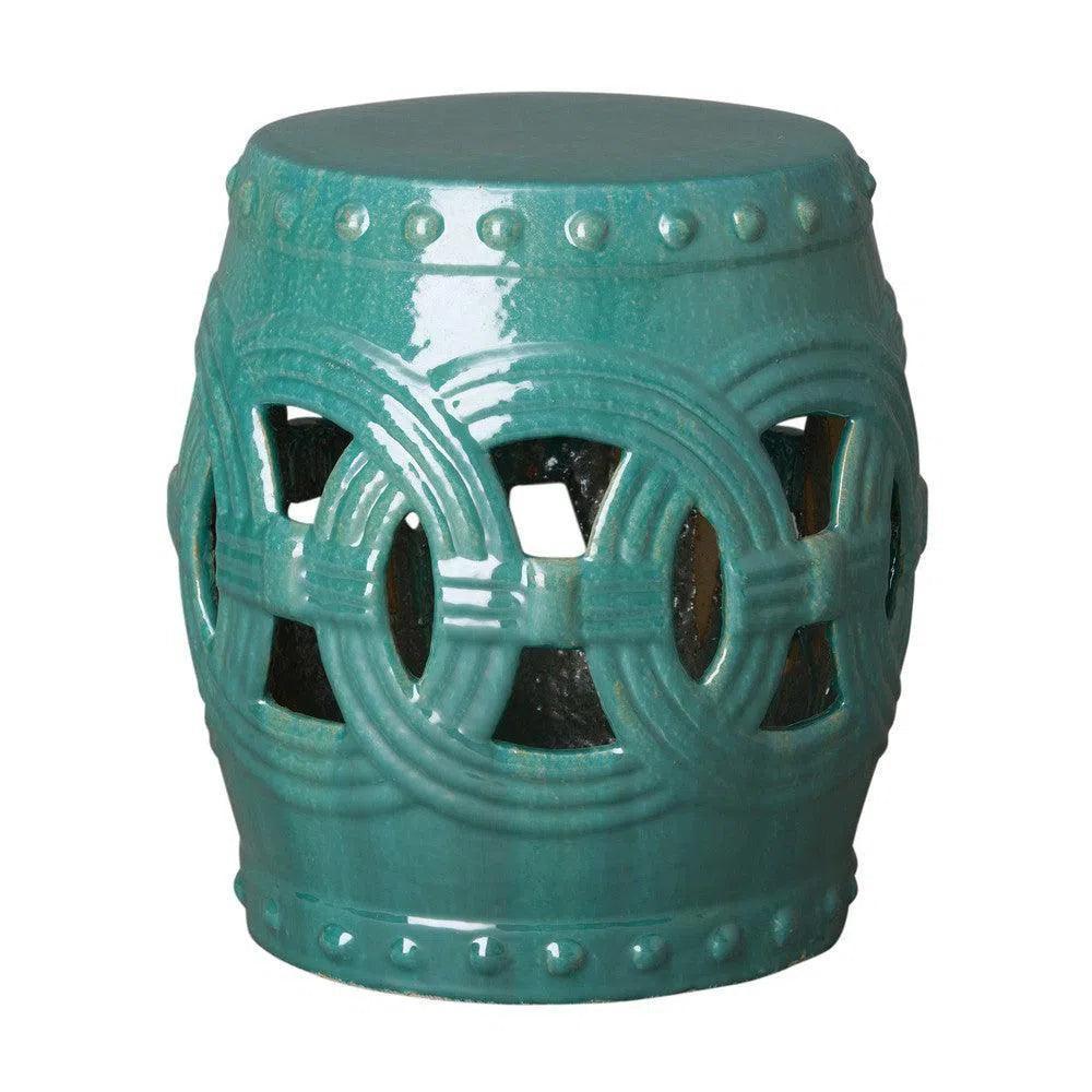 Teal ceramic stool with decorative patterns on a white background