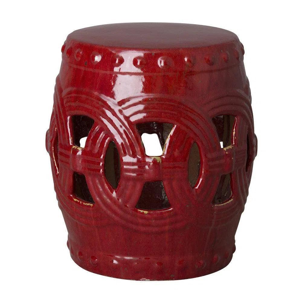 Red ceramic stool with decorative patterns on a white background