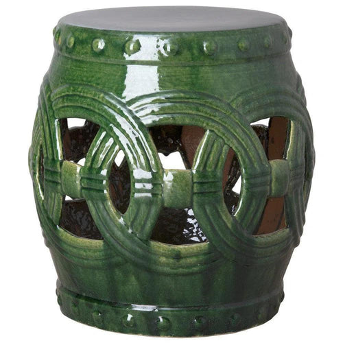 Green ceramic stool with decorative patterns on a white background