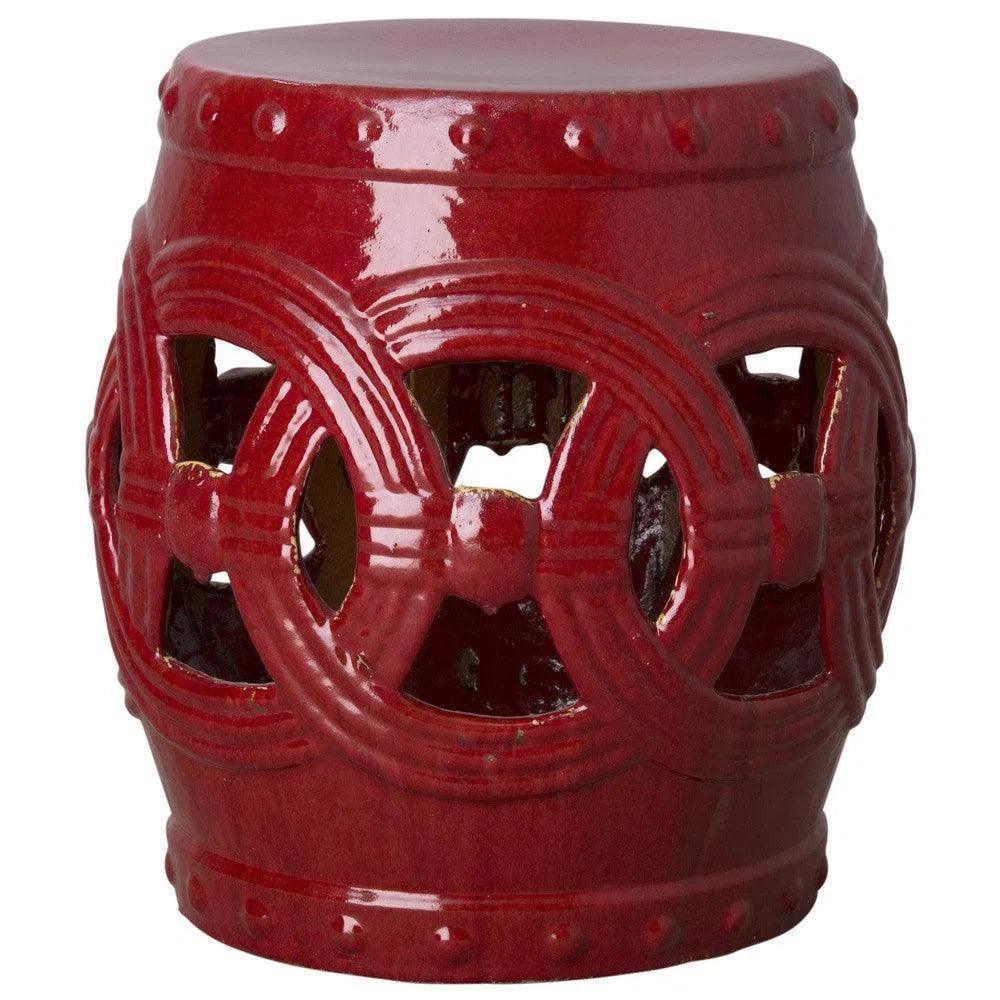 Red ceramic stool with intricate design on a white background