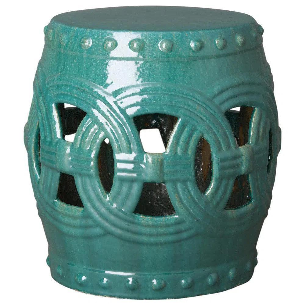 Teal ceramic stool with decorative patterns on a white background