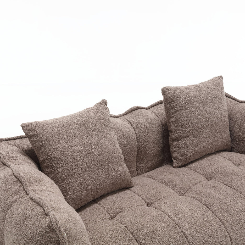 Brown textured sofa with cushions on a white background
