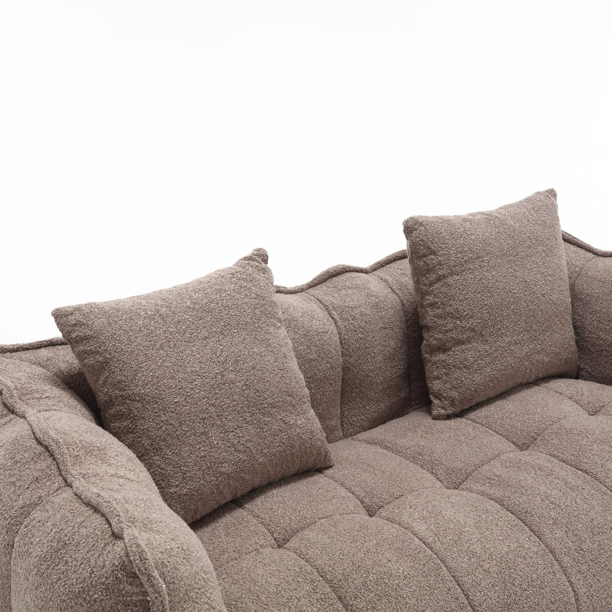 Brown textured sofa with cushions on a white background