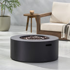 Black fire pit table in a modern outdoor setting with a chair and small table.