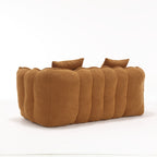 Brown sofa with three cushions on a white background