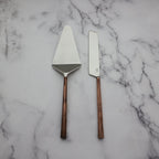 Two cake knives with copper handles on a marble surface