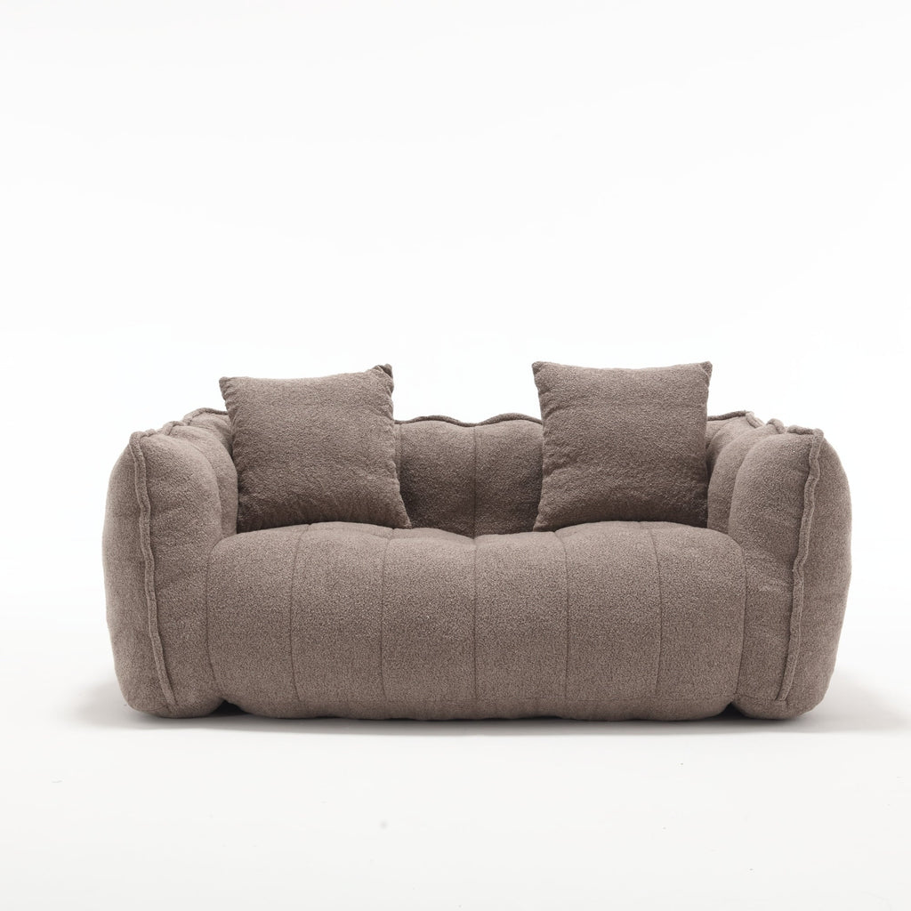 Brown sofa with two cushions on a white background
